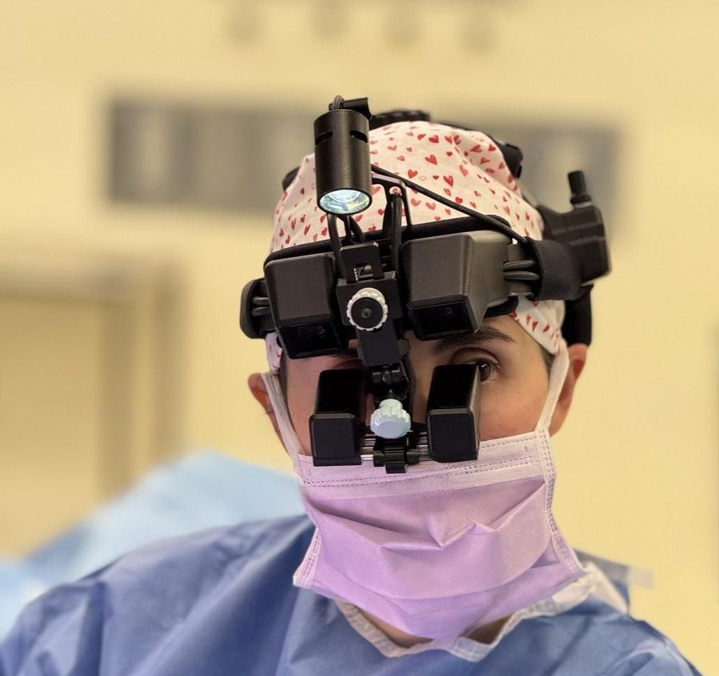 Dr. Eliana Saltzman wearing the SurgiSight wearable digital surgical microscope in the operating room